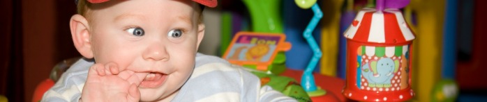 a baby with a hand on its chin